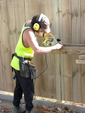 Joe Cutting Timber for the Retaining Wall